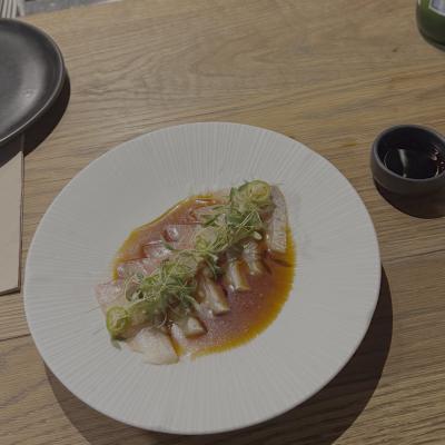 Kingfish crudo in a citrus ponzu with microgreens and sliced chili