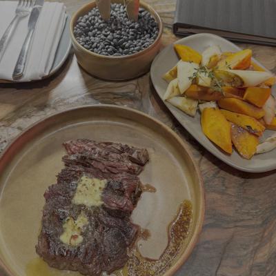Butter-basted skirt steak with roasted root vegetables and black beans