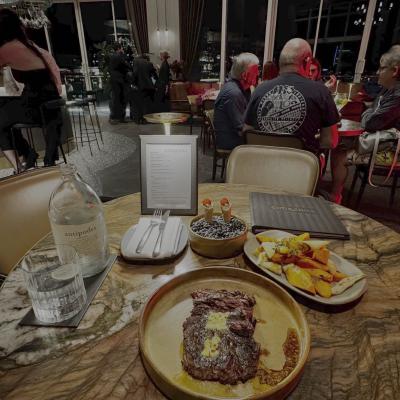 A dinner spread at Churchill — steak and roasted vegetables
